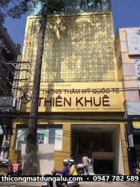 Mặt dựng alu vàng đục lỗ hoa văn, bảng hiệu Thẩm mỹ Quốc tế Thiên Khuê, quận 3