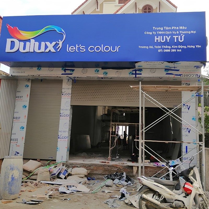 Mặt tiền đại lý sơn Dulux đang thi công, giàn giáo và khung ốp alu chưa hoàn thiện