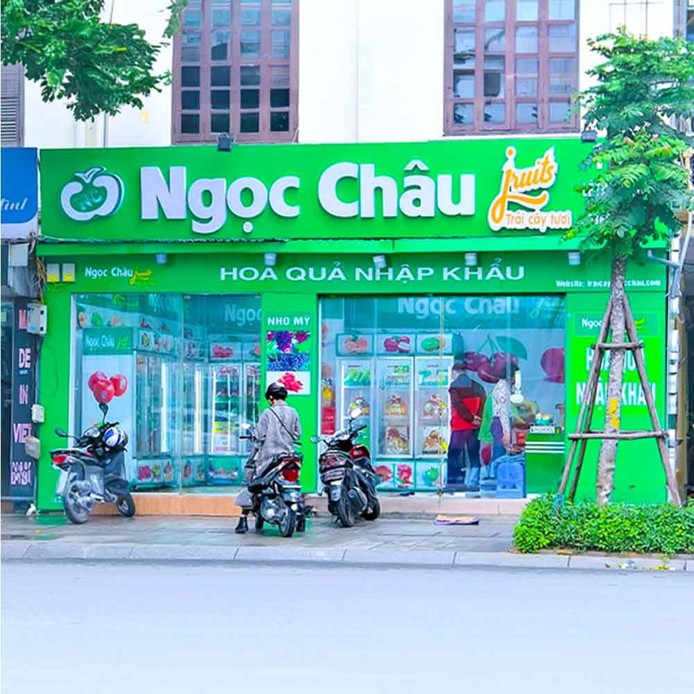 Cửa hàng hoa quả nhập khẩu Ngọc Châu mặt tiền xanh lá, chữ nổi trắng và logo quả táo