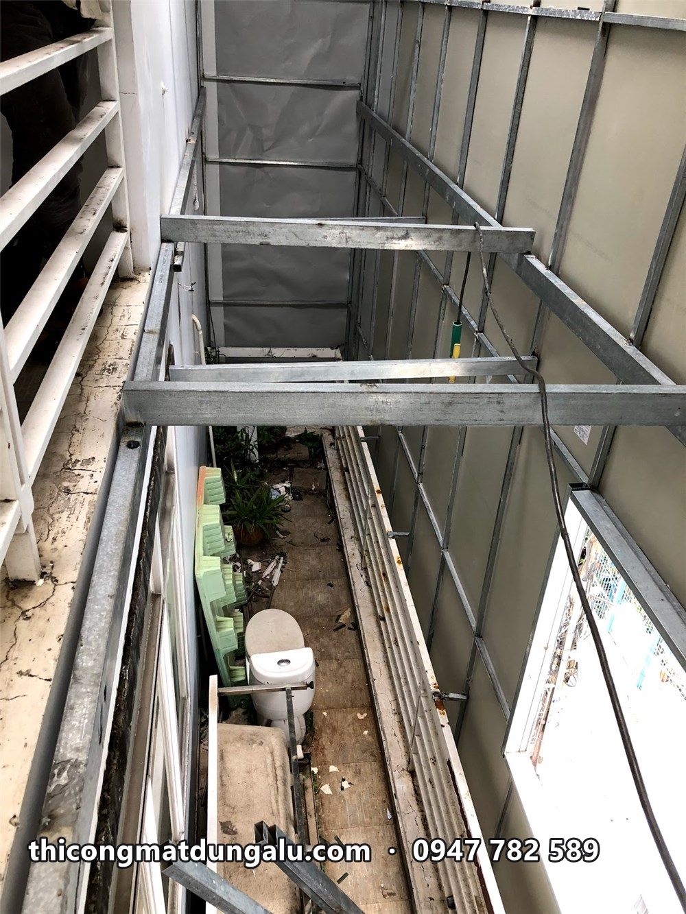 Khung sắt đứng và ngang trong khoảng giữa ban công và mặt dựng mới