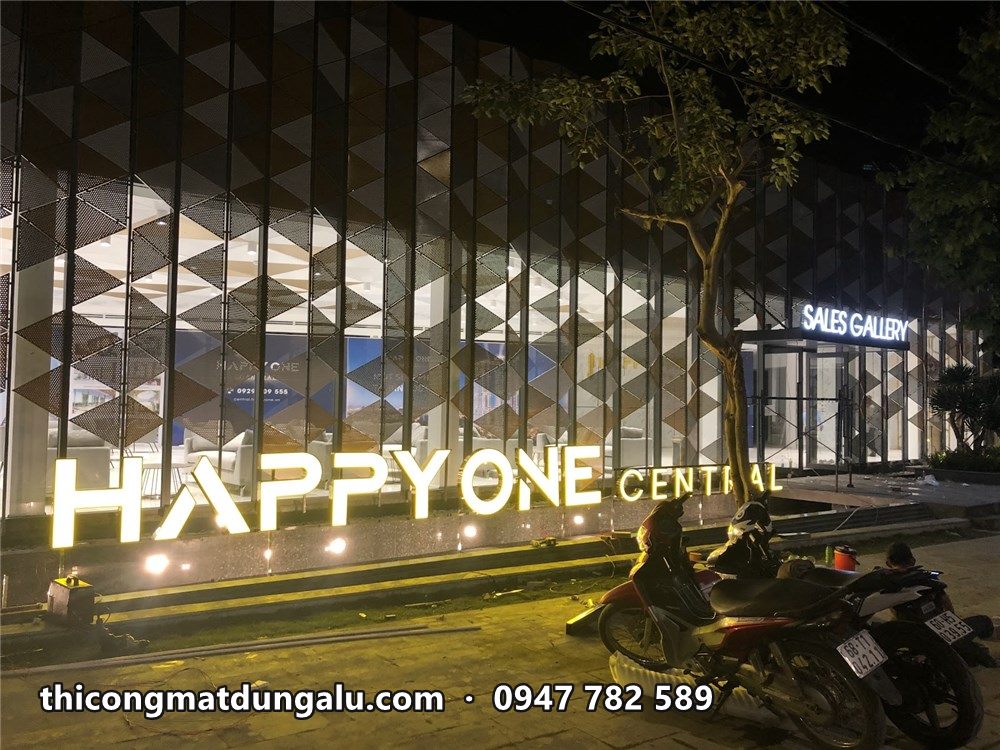 Chữ Happy One Central sáng đèn ban đêm trước mặt dựng tam giác