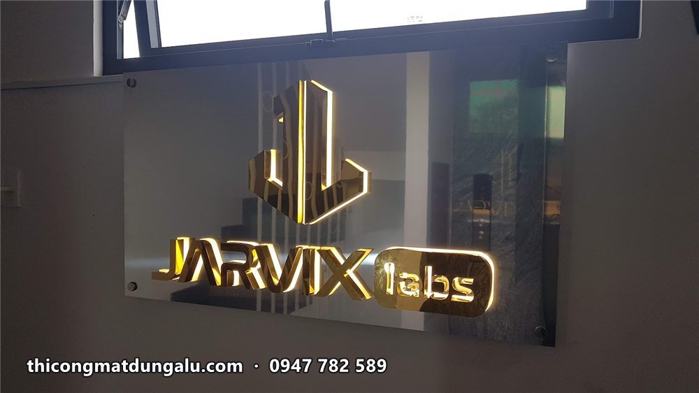 Logo Jarvix Labs inox vàng hắt sáng nhìn từ góc nghiêng